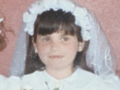 The author pictured in her first Holy Communion dress - she's a Catholic but not devout